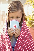 Small girl drinking out of a beaker (4th of July, USA)