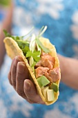 Woman holding taco