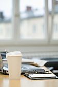 Coffee cup on desk in office