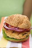 Woman holding grilled vegetable burger