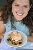 Woman holding burger