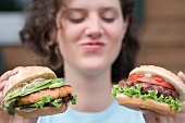 Woman with two different burgers