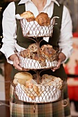 Woman holding tiered stand full of baked goods (Christmas)