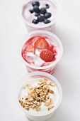 Three yoghurts with berries and with cereal