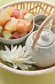 Fruit salad and tea in basket