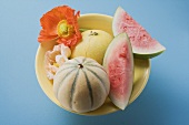 Three different melons in bowl (overhead view)