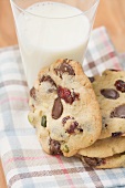 Chocolate chip cookies with cranberries, glass of milk