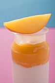 Mango yoghurt with wedge of mango