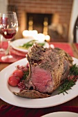 Rib of beef on Christmas table in front of fireplace