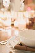 Christmas place-setting with place card by candlelight