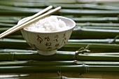 Rice in Asian bowl with chopsticks