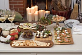 Assorted appetisers on table in front of fireplace (Christmas)