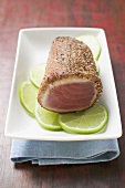 Seared, seasoned tuna fillet on lime slices