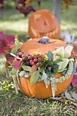 Autumnal garden decoration with pumpkins and flowers