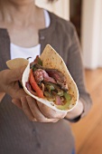 Woman holding beef tortilla