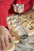 Child cutting out biscuits