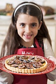 Girl holding freshly-baked fig tart