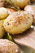 Baked potatoes in roasting tin (close-up)