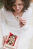 Woman taking pinwheel biscuit out of box