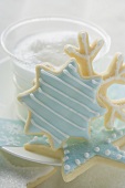 Christmas biscuits in front of glass of milk foam