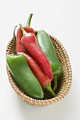 Red and green chillies in basket