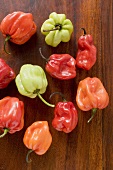 Different coloured Habanero chillies on wooden background