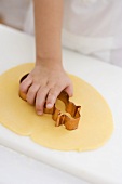 Child cutting out biscuit