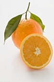 Orange with stalk and leaf, half an orange