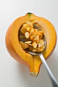 Hollowing out Hokkaido pumpkin with spoon