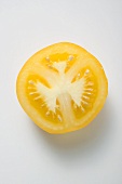 Half a yellow tomato (overhead view)