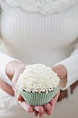 Frau hält Cupcake