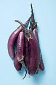 Several purple aubergines with drops of water (overhead view)