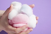 Hands holding cotton wool balls