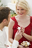 Man handing woman a cinnamon star