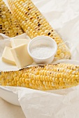 Grilled corn on the cob with salt and pieces of butter