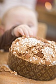 Baby reaching for almond cake