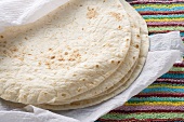 Freshly-baked tortillas on kitchen roll (Mexico)