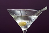 Martini with olive in glass