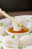 Dipping dim sum in chilli sauce