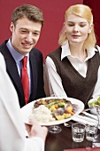 Person serving lunch to office colleagues