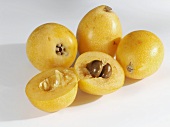 Several loquats, whole and halved