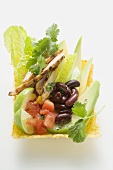 Chicken, vegetables, lime wedges & coriander in taco shell