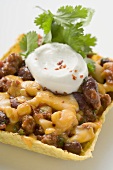 Chili con carne with cheese & sour cream in corn shell