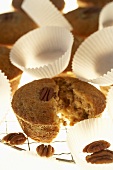 Freshly baked pecan muffins with paper cases