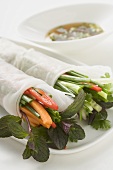 Rice paper rolls filled with vegetables, glass noodles & herbs, sauce
