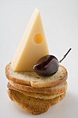 Emmental cheese and olive on slices of white bread