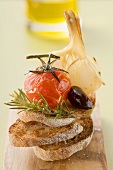 Fried cherry tomato, olive and garlic on toast