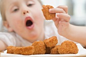 Little girl eating chicken nuggets