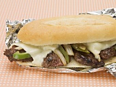 Beef, cheese, green pepper & onion sandwich in aluminium foil