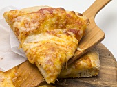Slice of pizza Margherita (tomato & cheese pizza) on server